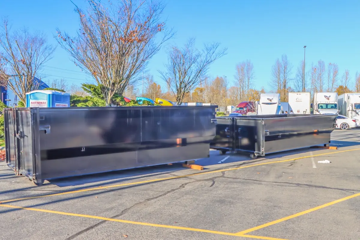 Professional dumpster rental service with roll-off container on residential driveway in Idylwood